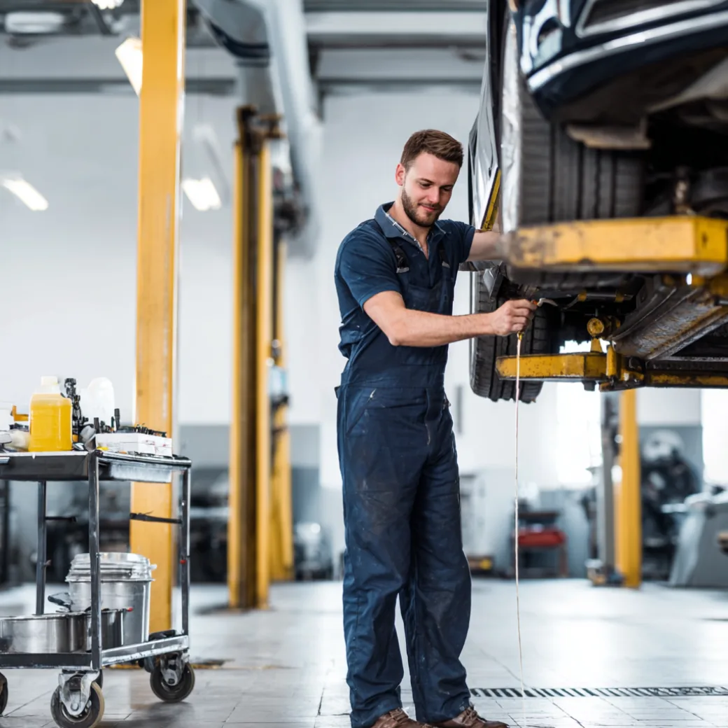Mechanic working under car on lift