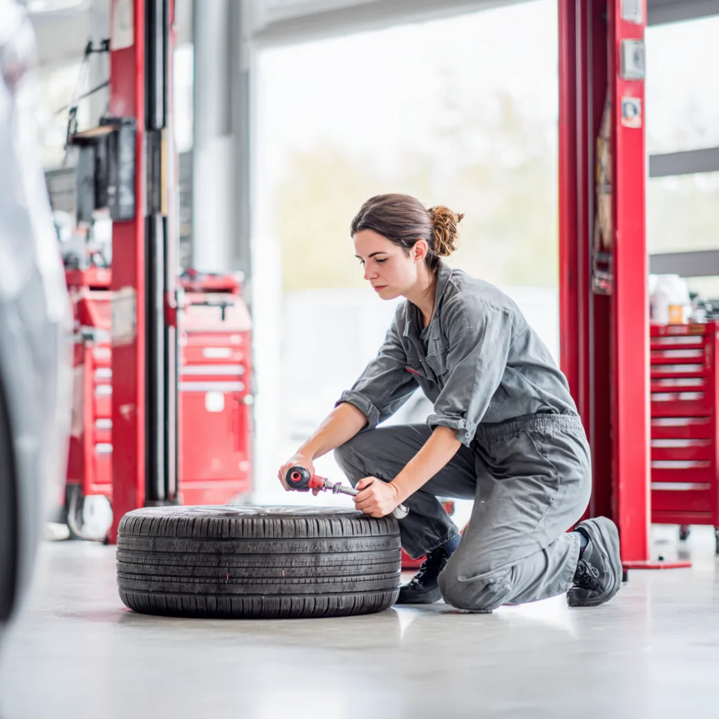 Mechanic working on tire — show the work